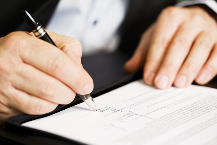 Man Signing Documents